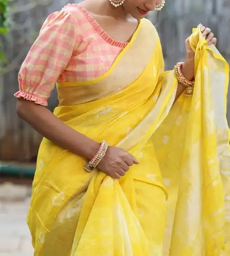 pink and white checks printed puff sleeve blouse paired with yellow Saree