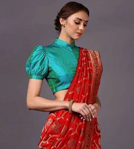 peacock green half sleeve puff blouse paired with red saree.
