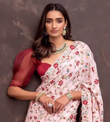 maroon organza puff blouse paired with white printed saree