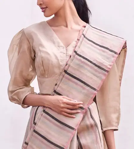 3/4th sleeve beige puff blouse paired with cotton striped saree