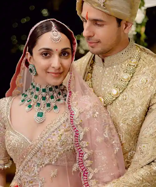 Kiara Advani wearing diamine and emerald studded bridal jewelry