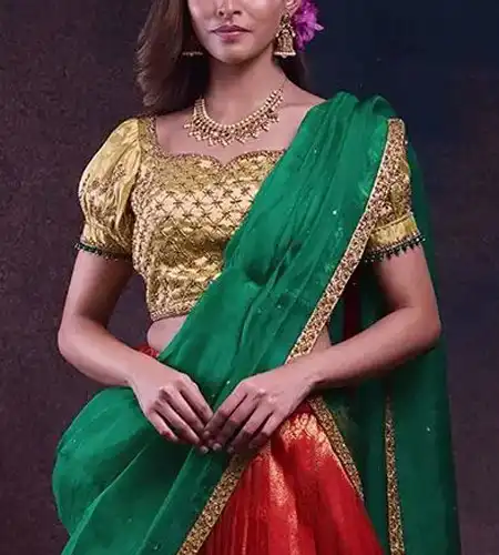 short sleeve gold puff blouse paired with red lehenga and green dupatta