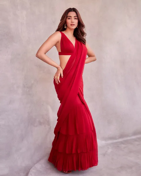 Red ruffle saree paired with corset blouse.