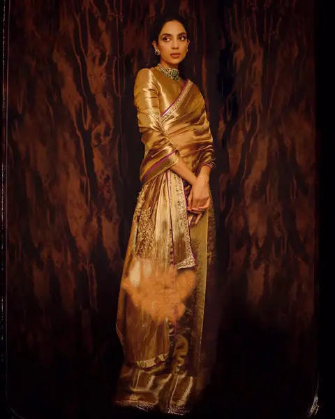 Sobhita worn golden saree with matching high neck blouse.
