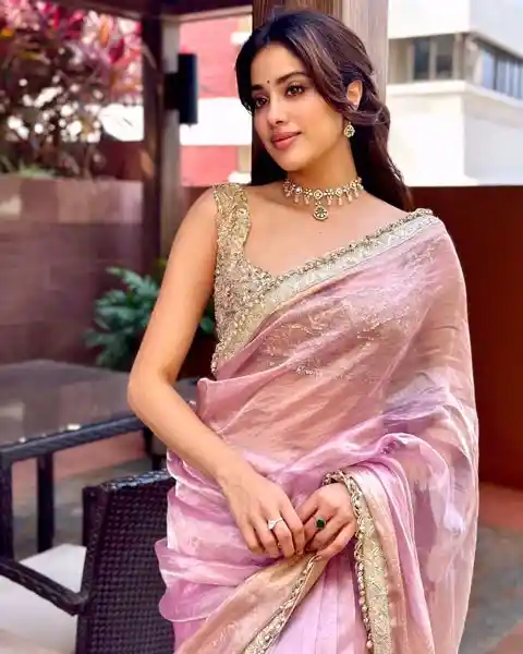 Janhvi Kapoor wearing light pink tissue saree with sleeveless blouse